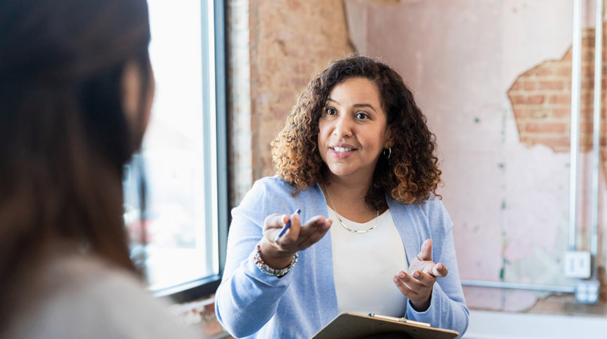 Woman smiling about using Benchmarks 360 leadership assessments, a suite of industry-leading 360 degree leadership assessments
