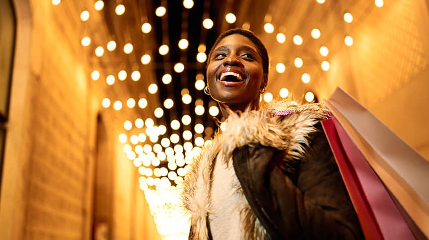 Woman smiling as she learns how to Maximize Joy and 4 Savoring Strategies for the Holidays and Beyond