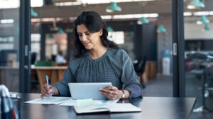 Woman smiling pondering using leadership analytics data to plan development and measure the impact of training with leadership development evaluation services