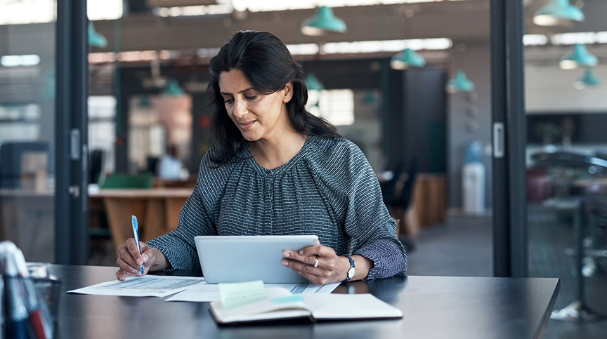 Woman smiling pondering using leadership analytics data to plan development and measure the impact of training with leadership development evaluation services