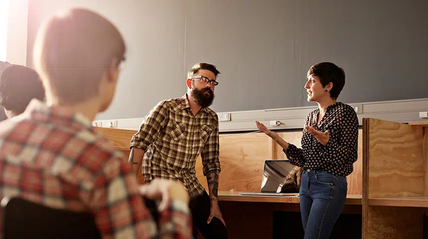 woman discussing effective influencing and being an influential leader with a colleague at work