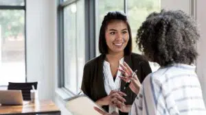 mature leader talking to younger leader displaying coaching and mentoring skills