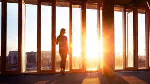 image of business woman looking out window rethinking leadership