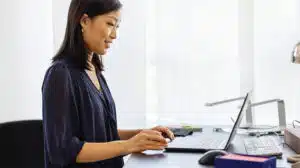 Image of a woman engaging in a virtual coaching experience on laptop